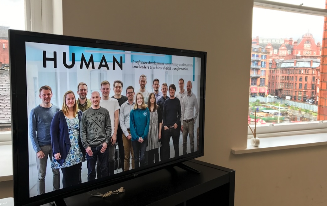 Human team photo displayed on a screen at the Human offices