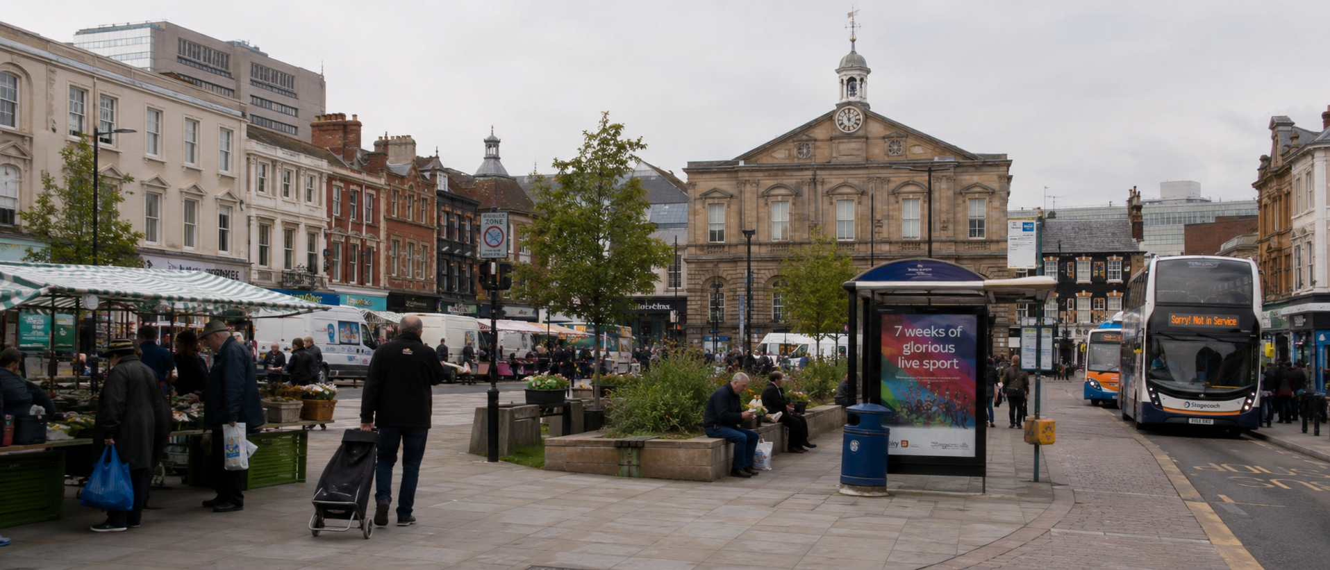 A market square in a British town with people going about ordinary business